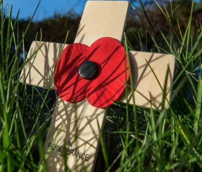 A small wooden cross laid in rembembrance of those that gave their lives. Remembrance Sunday KIllamarsh